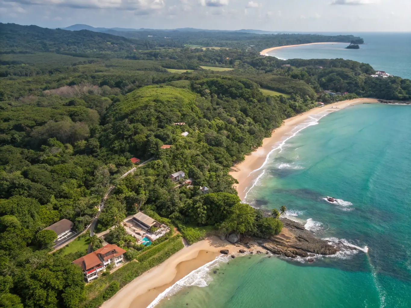 A serene aerial view of a lush green land plot in Ahangama, Sri Lanka, showcasing its natural beauty and potential for development. The image should convey a sense of tranquility and investment opportunity.